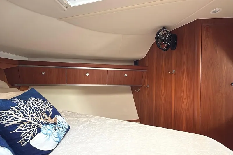 Slide: The Image of Luxurious cabin interior of 2004 Tiara Yachts 3600 Sovran with wood finish and decorative pillows. - 38