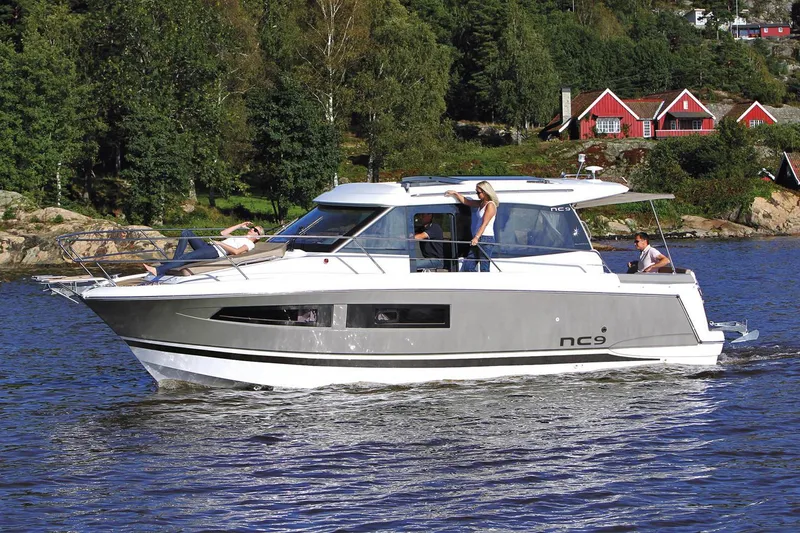 Slide: The Image of Manufacturer Provided Image: 2018 Jeanneau NC 9 boat cruising on a lake with people on board. - 14