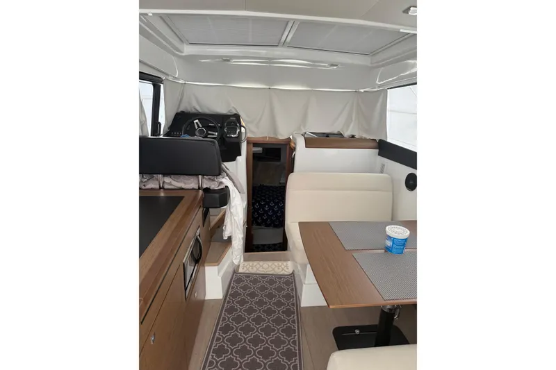 Slide: The Image of Interior of 2019 Jeanneau NC 9 boat with modern seating and helm station. - 7