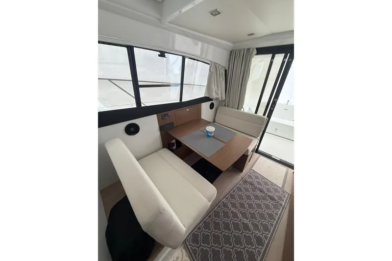 Slide: The Image of Interior of 2019 Jeanneau NC 9 boat with cozy seating and table. - 8