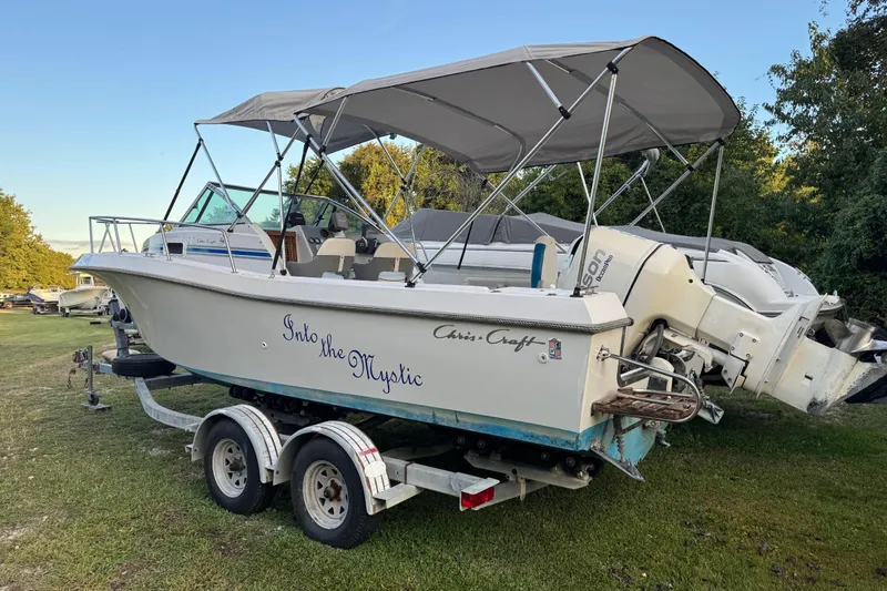 The Image of 1988 Chris-Craft 215 Sea Hawk boat on trailer, named "Into the Mystic." - 1
