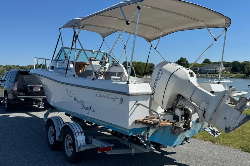 Slide: The Image of 1988 Chris-Craft 215 Sea Hawk boat on trailer, with Johnson outboard motor. - 11