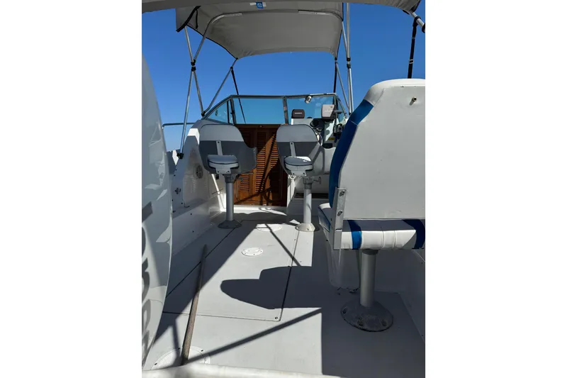 Slide: The Image of 1988 Chris-Craft 215 Sea Hawk boat interior with seating and steering console. - 20