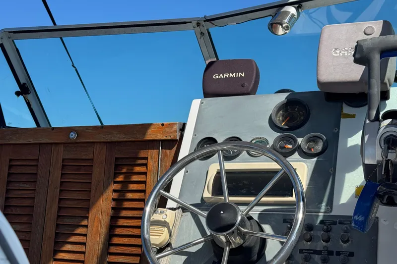 Slide: The Image of 1988 Chris-Craft 215 Sea Hawk dashboard with Garmin navigation system and steering wheel. - 22