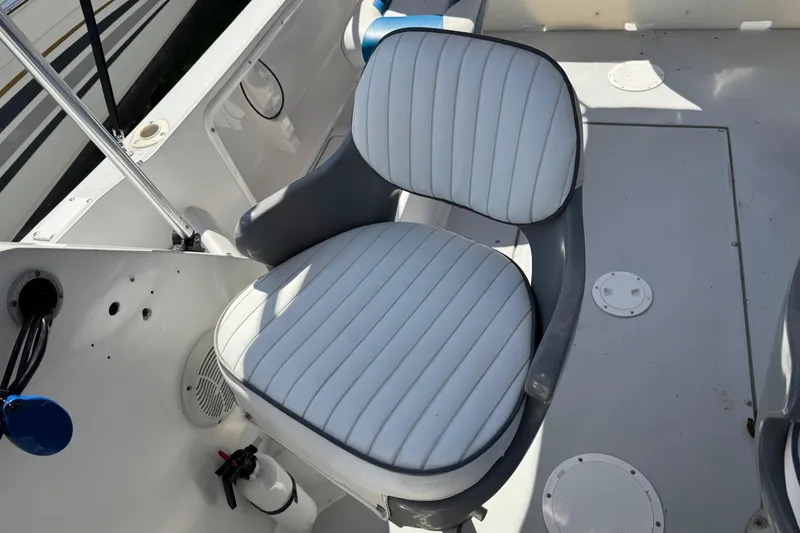 Slide: The Image of 1988 Chris-Craft 215 Sea Hawk boat seat with white and gray upholstery. - 30