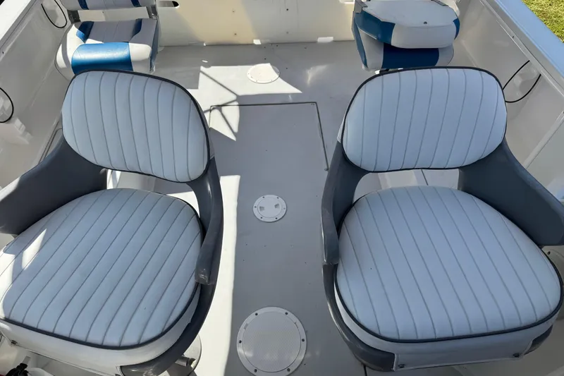 Slide: The Image of 1988 Chris-Craft 215 Sea Hawk boat interior with white and blue seating. - 31