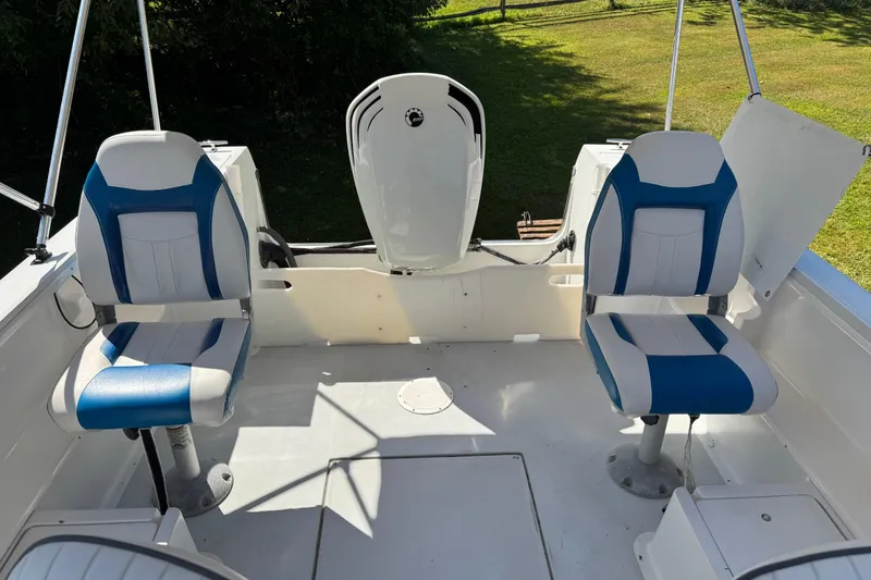 Slide: The Image of 1988 Chris-Craft 215 Sea Hawk boat interior with two blue and white seats. - 32