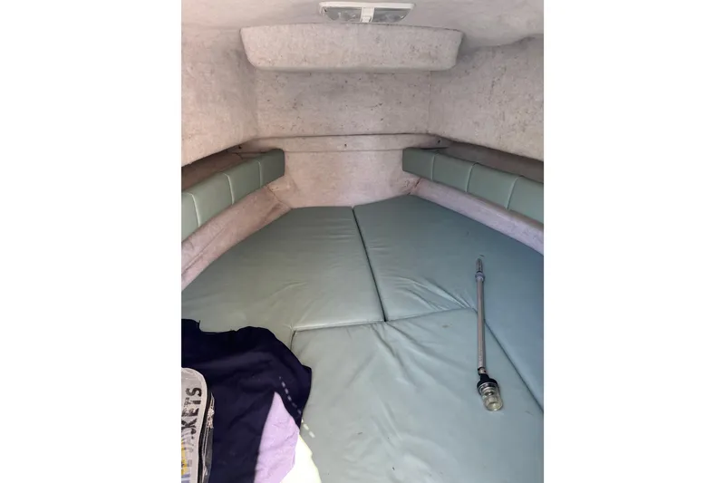 Slide: The Image of Interior cabin of 1988 Chris-Craft 215 Sea Hawk boat with cushioned seating. - 36
