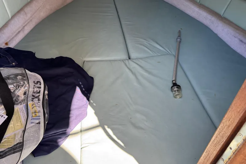 Slide: The Image of 1988 Chris-Craft 215 Sea Hawk cabin interior with cushions and gear. - 37