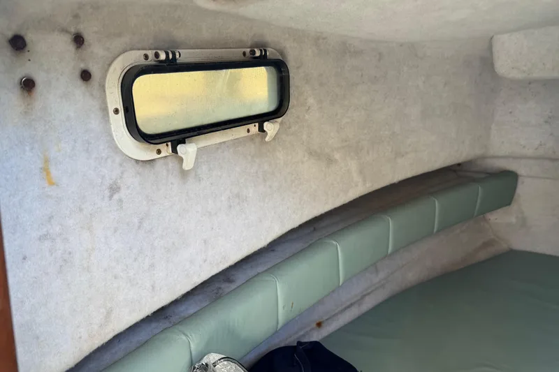 Slide: The Image of Interior cabin of 1988 Chris-Craft 215 Sea Hawk boat with window and seating. - 39