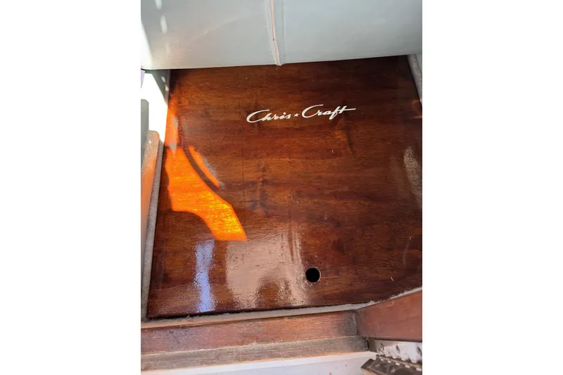 Slide: The Image of Polished wooden surface with Chris-Craft logo on 1988 215 Sea Hawk boat. - 40