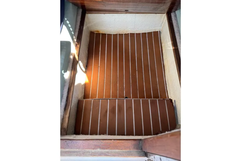 Slide: The Image of 1988 Chris-Craft 215 Sea Hawk interior with wooden flooring and white trim. - 41