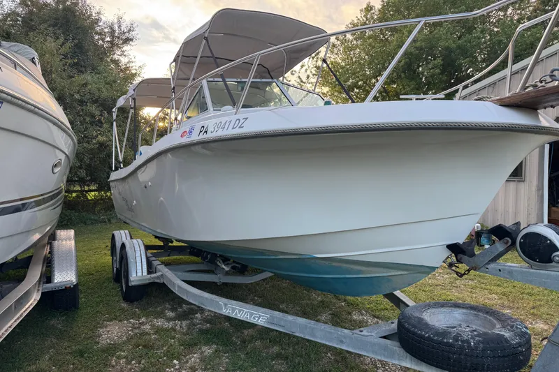 Slide: The Image of 1988 Chris-Craft 215 Sea Hawk boat on trailer, parked outdoors. - 6