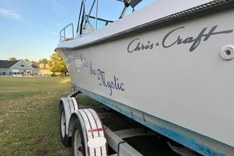 Slide: The Image of 1988 Chris-Craft 215 Sea Hawk boat on trailer, side view with "Into the Mystic" text. - 7