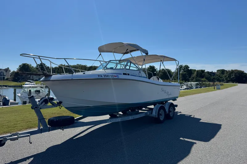 Slide: The Image of 1988 Chris-Craft 215 Sea Hawk boat on trailer, sunny day, marina background. - 9