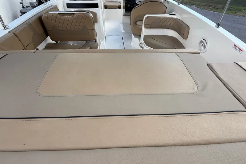 Slide: The Image of 2022 Bayliner VR6 Bowrider OB interior with beige seating and spacious layout. - 7