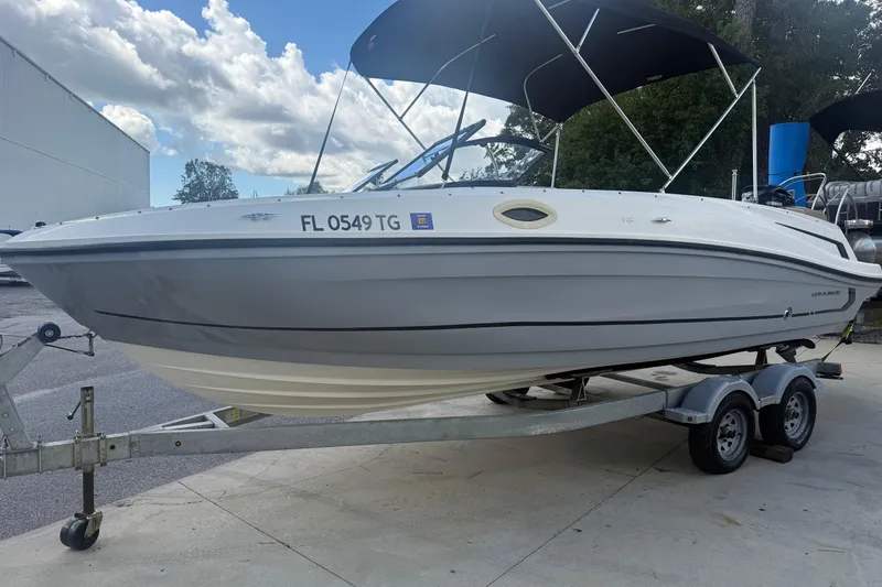 Slide: The Image of 2022 Bayliner VR6 Bowrider OB on trailer, parked outdoors under cloudy sky. - 9