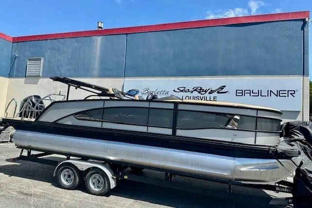 The Image of 2026 Barletta L23UC pontoon boat on trailer outside dealership. - 0