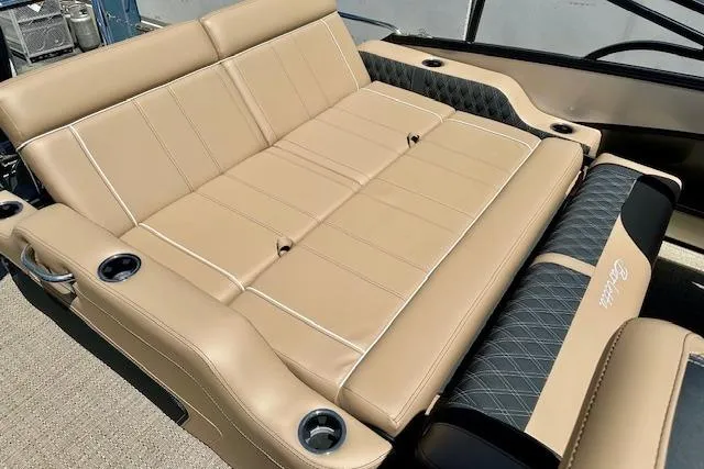 Slide: The Image of Luxurious seating on 2026 Barletta L23UC boat with tan upholstery and cup holders. - 10