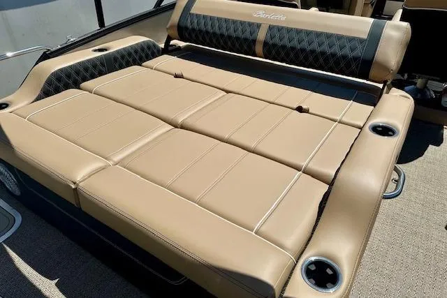 Slide: The Image of Luxurious seating on 2026 Barletta L23UC boat with tan upholstery and cup holders. - 11