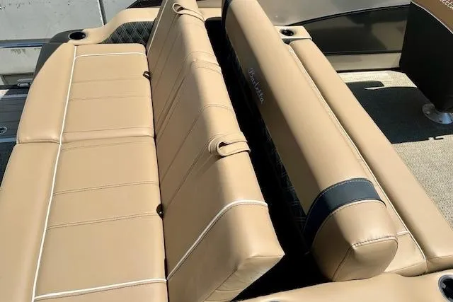 Slide: The Image of 2026 Barletta L23UC boat interior with tan leather seating and cup holders. - 9