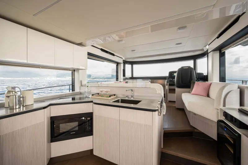 Slide: The Image of Luxurious interior of 2027 Absolute 50 Navetta yacht with modern kitchen and seating area. - 21