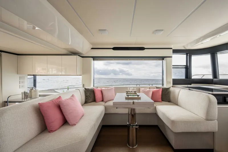 Slide: The Image of Luxurious interior of 2027 Absolute 50 Navetta yacht with ocean view and plush seating. - 28