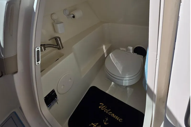 Slide: The Image of 2021 Boston Whaler 240 Vantage boat interior bathroom with toilet and sink. - 15