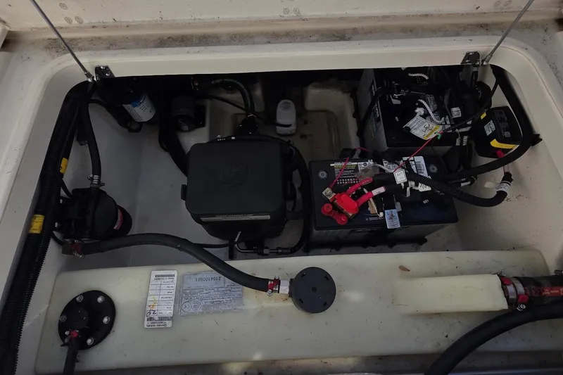 Slide: The Image of 2021 Boston Whaler 240 Vantage battery compartment with wiring and components. - 18