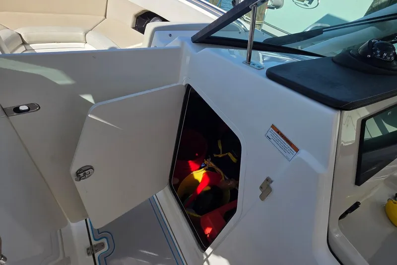 Slide: The Image of 2021 Boston Whaler 240 Vantage boat interior with open storage compartment. - 20