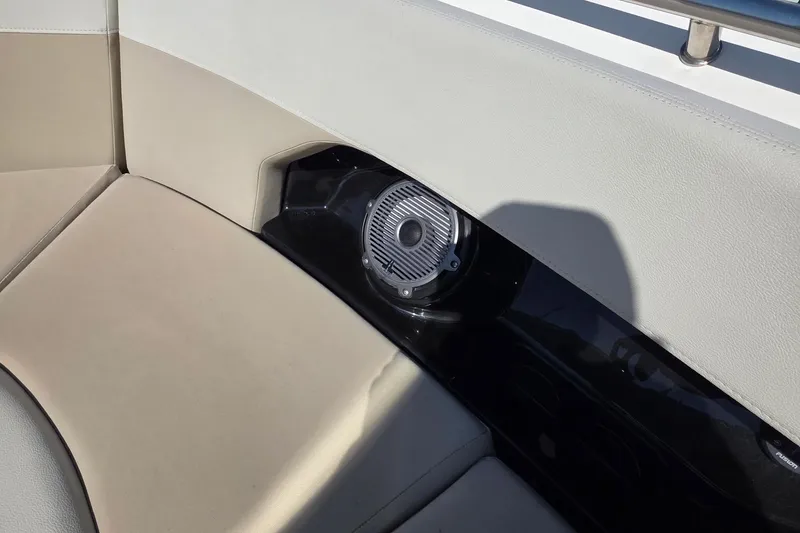 Slide: The Image of 2021 Boston Whaler 240 Vantage interior with beige seating and built-in speaker. - 22