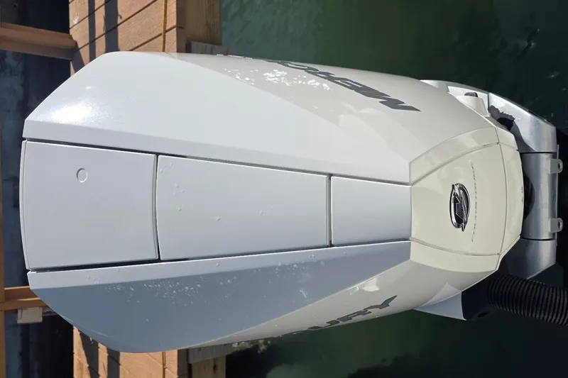 Slide: The Image of Outboard motor of a 2021 Boston Whaler 240 Vantage boat, docked by the water. - 24