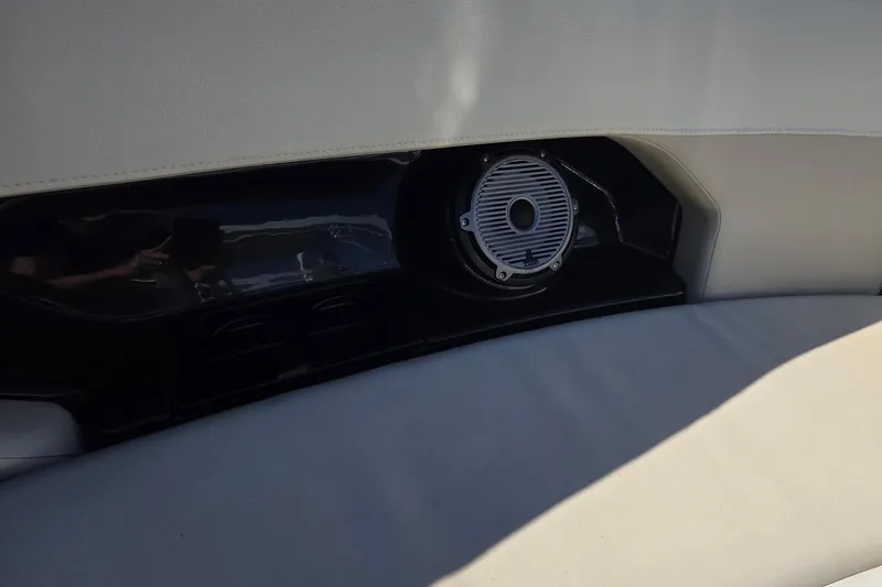 Slide: The Image of 2021 Boston Whaler 240 Vantage interior speaker detail with cushioned seating. - 25