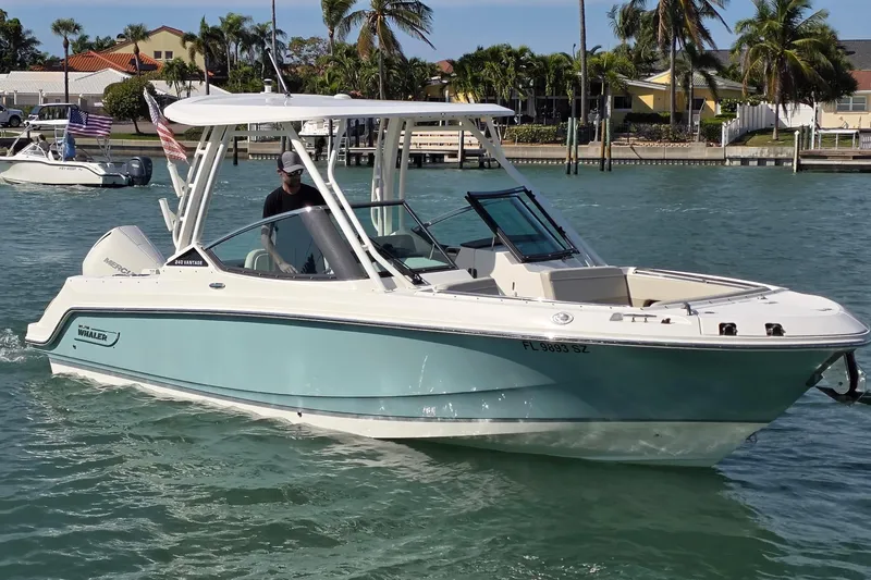 Slide: The Image of 2021 Boston Whaler 240 Vantage boat cruising on a sunny day in coastal waters. - 3