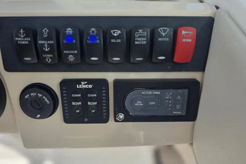 Slide: The Image of Control panel of a 2021 Boston Whaler 240 Vantage boat with various switches. - 30