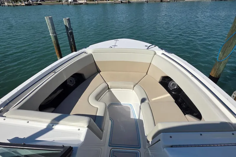 Slide: The Image of 2021 Boston Whaler 240 Vantage boat interior with cushioned seating and water view. - 31