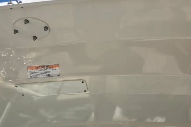Slide: The Image of 2021 Boston Whaler 240 Vantage boat hull with warning label and mounting points. - 35
