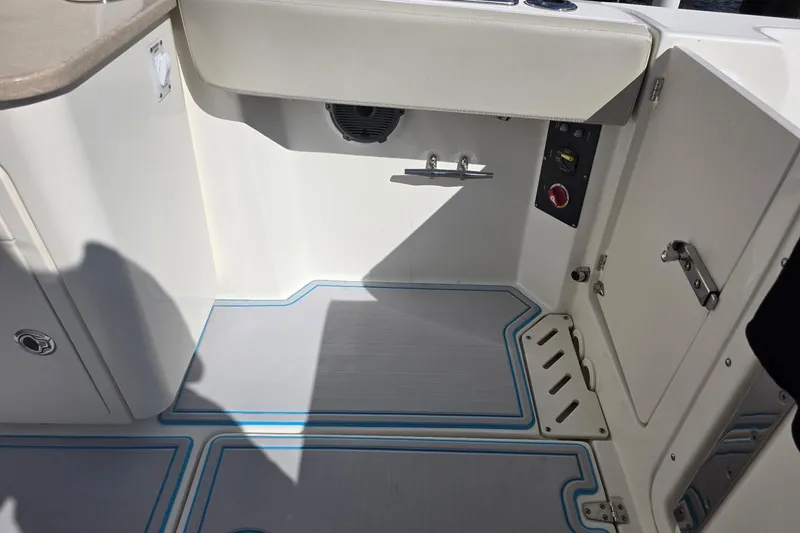 Slide: The Image of Interior view of a 2021 Boston Whaler 240 Vantage boat, showcasing seating and storage. - 38