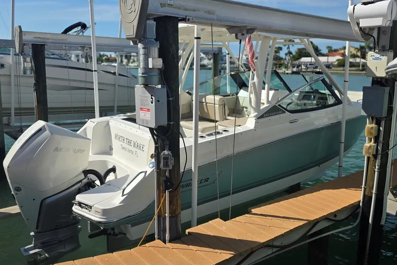 Slide: The Image of 2021 Boston Whaler 240 Vantage boat docked, featuring a Mercury engine. - 8