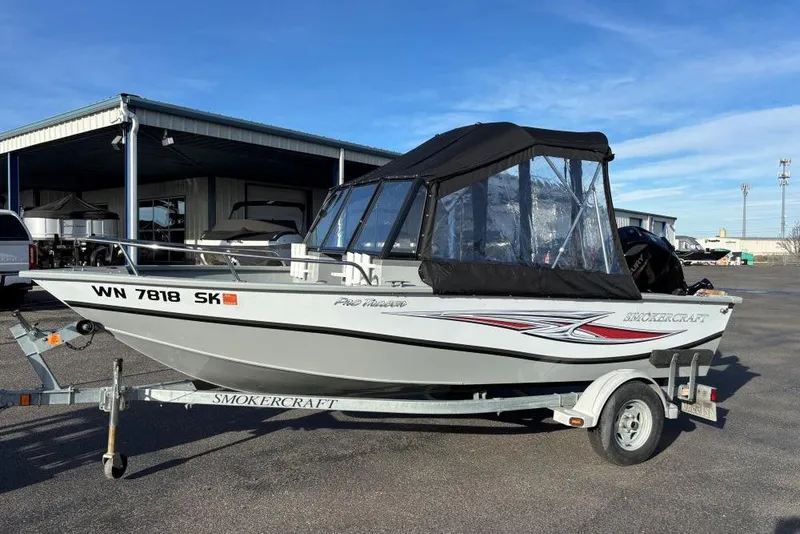 The Image of 2016 Smoker Craft Pro Tracer 162 boat on trailer, parked outdoors. - 0