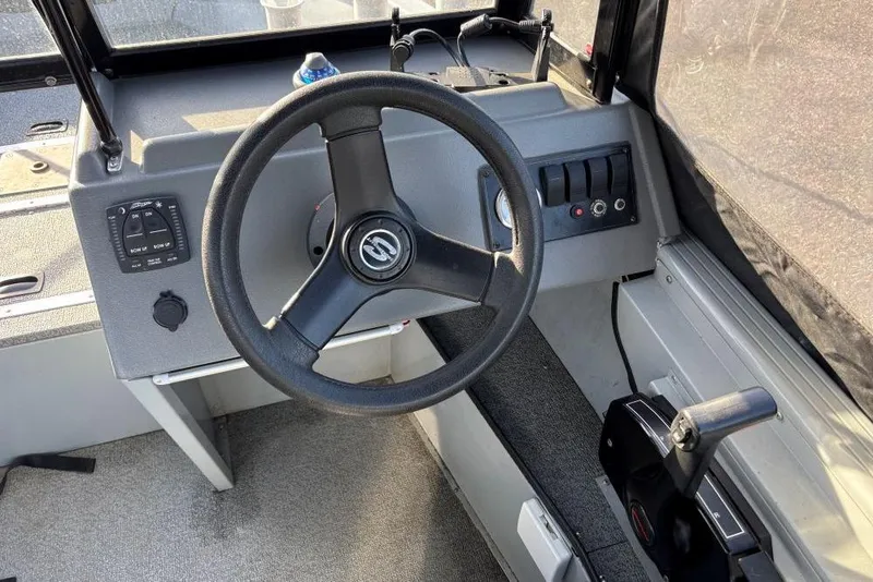 Slide: The Image of 2016 Smoker Craft Pro Tracer 162 boat dashboard with steering wheel and controls. - 3