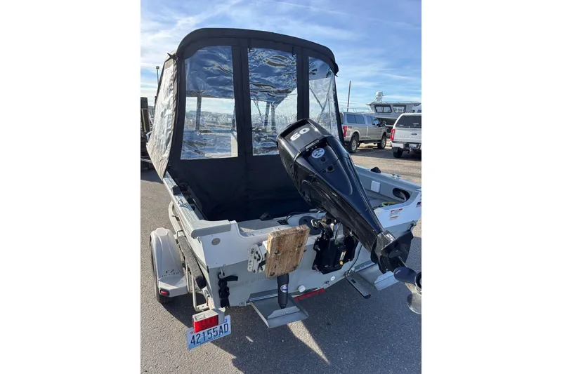 Slide: The Image of 2016 Smoker Craft Pro Tracer 162 boat with outboard motor and protective cover. - 6