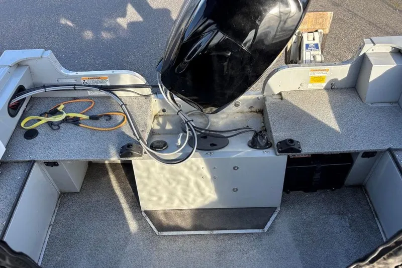 Slide: The Image of 2016 Smoker Craft Pro Tracer 162 boat interior with motor and storage compartments. - 8