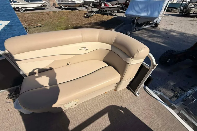 Slide: The Image of 2015 Bennington 20 SF boat interior with beige seating and shadow. - 3