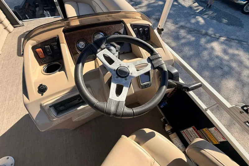 Slide: The Image of Steering console of a 2015 Bennington 20 SF pontoon boat with gauges and controls. - 4