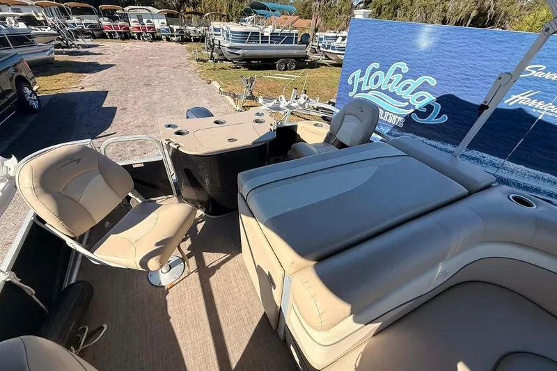 Slide: The Image of 2015 Bennington 20 SF pontoon boat interior with beige seating and fishing setup. - 5