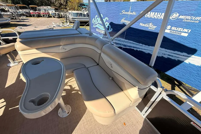 Slide: The Image of 2015 Bennington 20 SF pontoon boat interior with beige seating and table. - 8