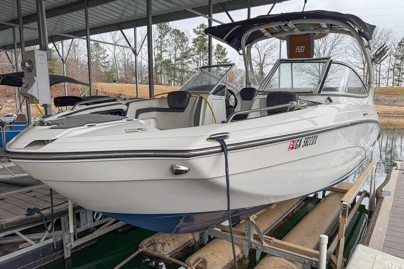 Slide: The Image of 2019 Yamaha Boats 242 Limited S E-Series docked under a covered marina. - 2