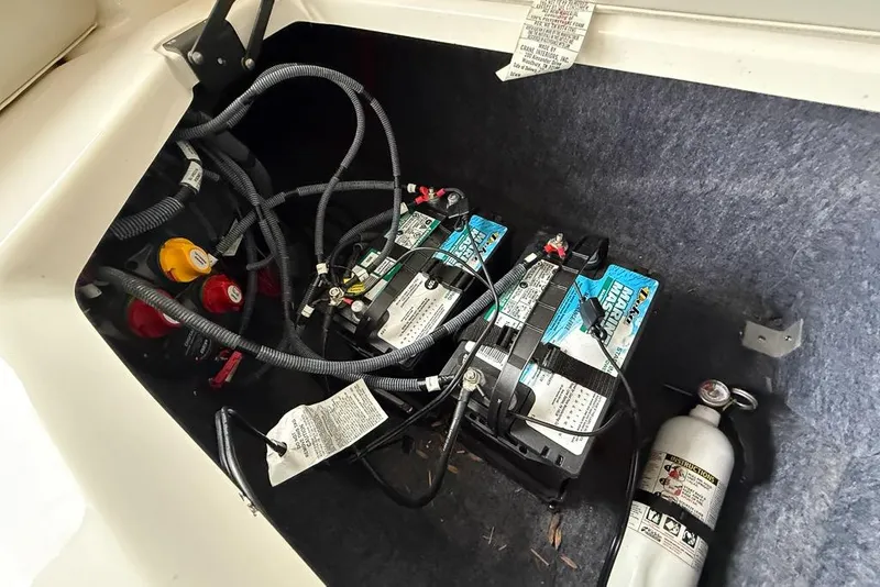 Slide: The Image of 2019 Yamaha Boats 242 Limited S E-Series battery compartment with fire extinguisher. - 25