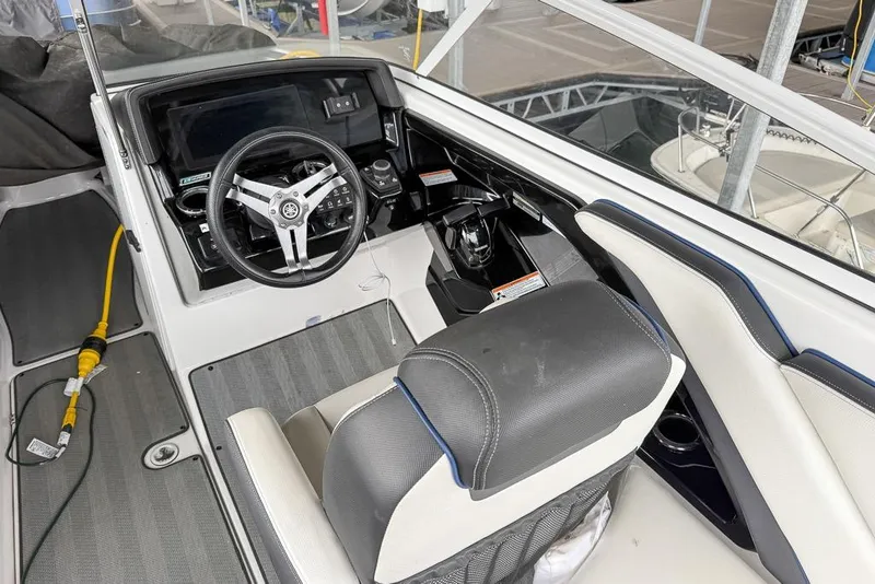 Slide: The Image of 2019 Yamaha Boats 242 Limited S E-Series cockpit with steering wheel and dashboard controls. - 5